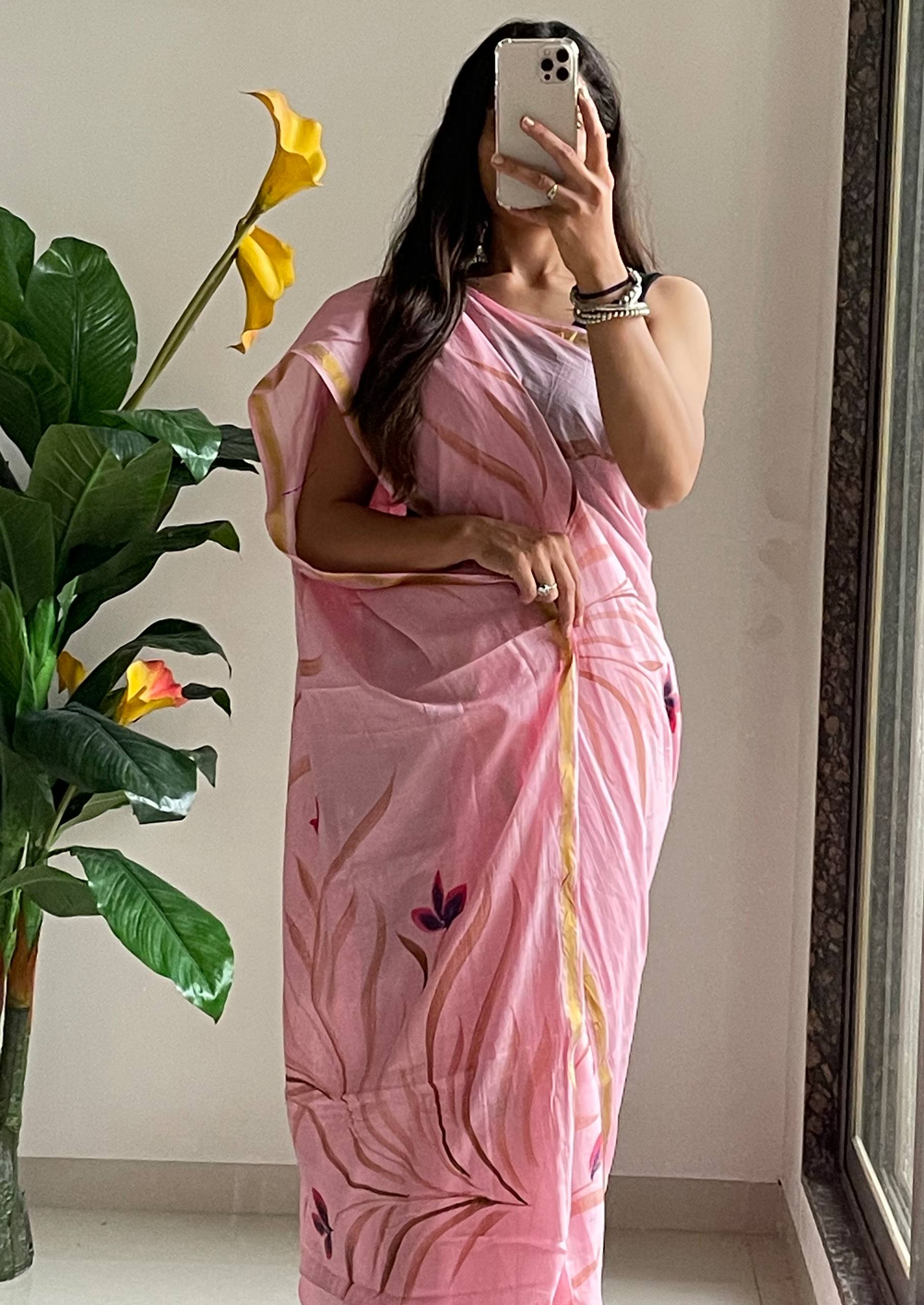 Elegant Soft Pink Hand-Painted Floral Saree With Subtle Golden Border