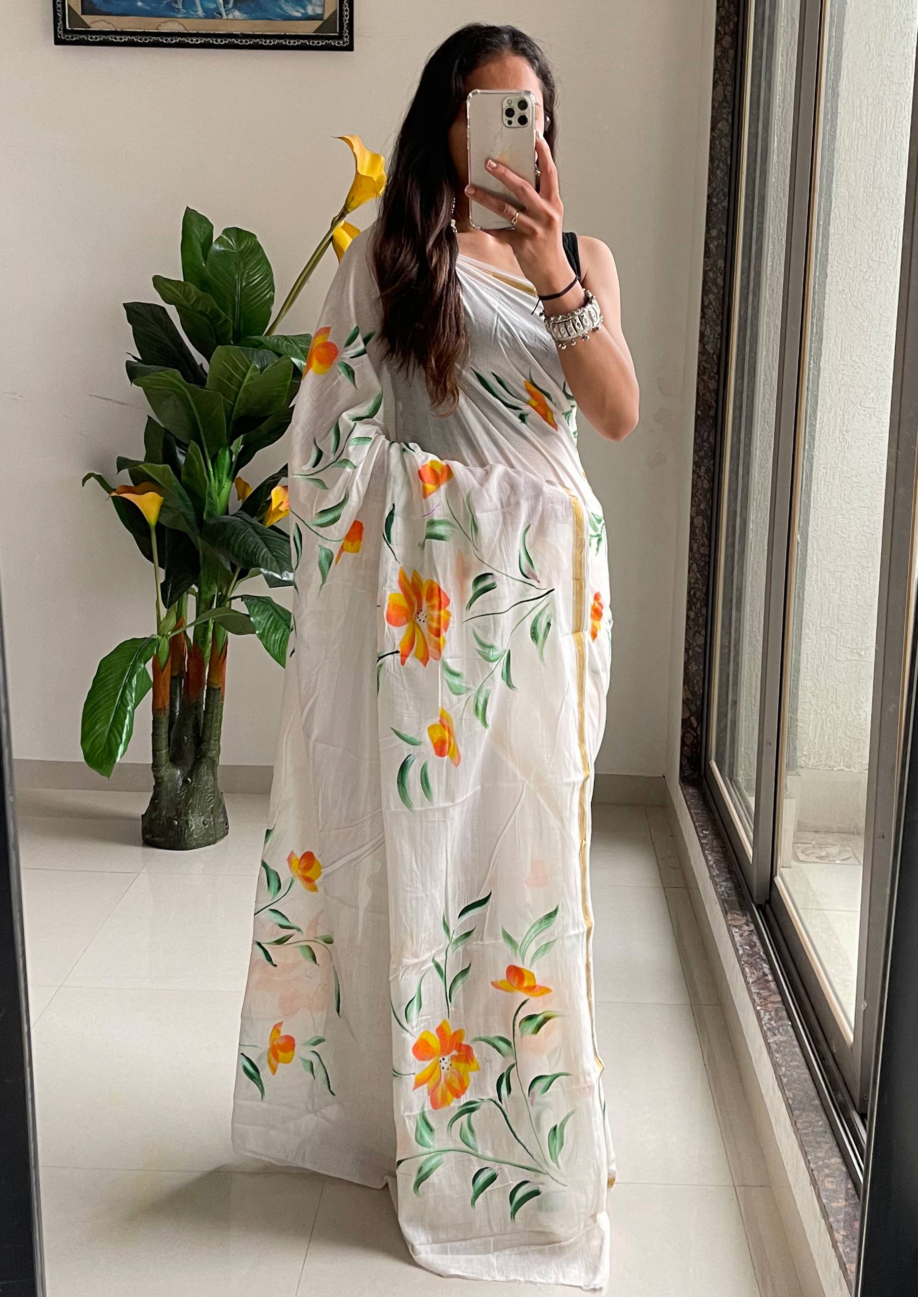 Elegant White Saree With Hand-Painted Yellow and Orange Floral Designs