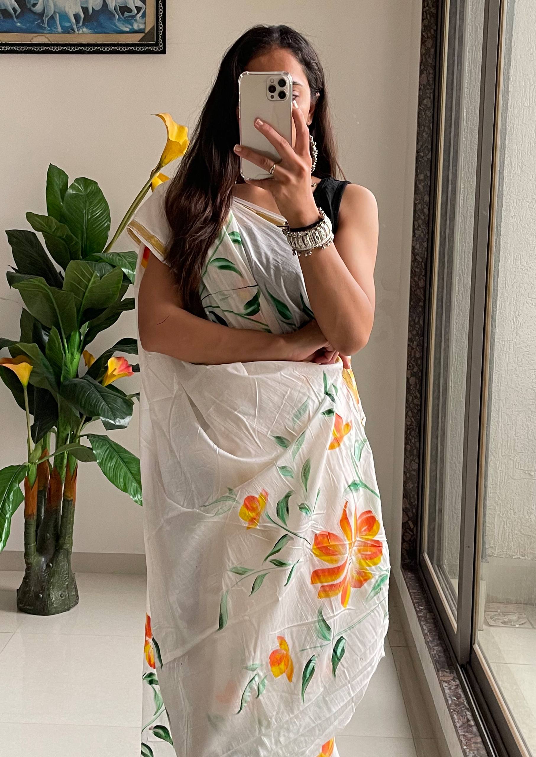 Elegant White Saree With Hand-Painted Yellow and Orange Floral Designs