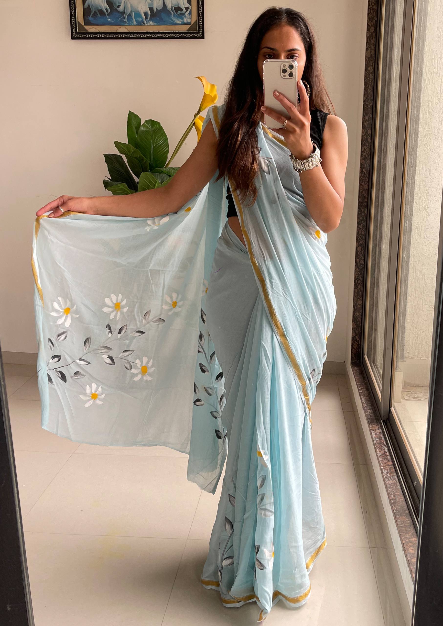 "A Serene Blue Saree With Soft Yellow and White Floral Accents"