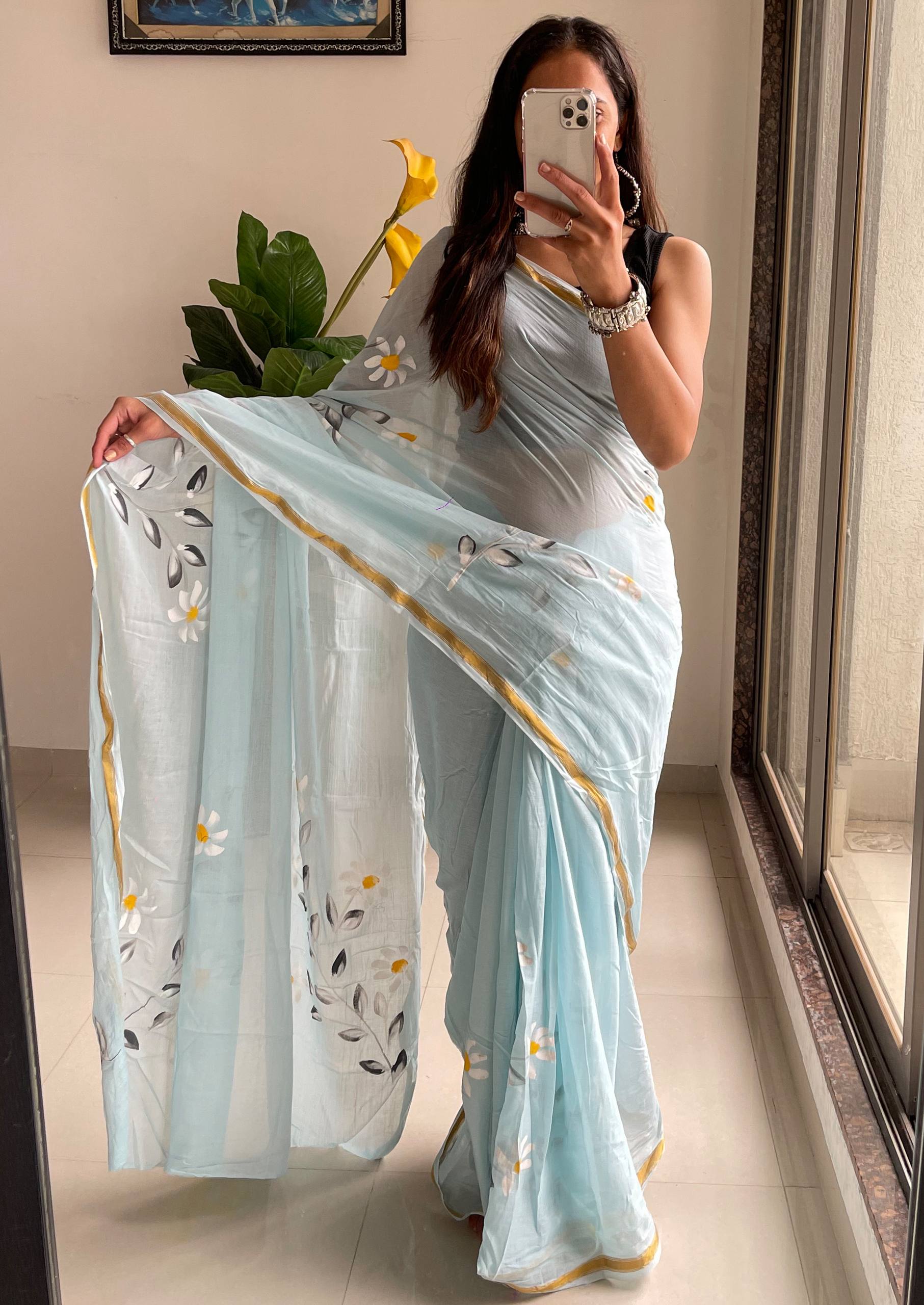 "A Serene Blue Saree With Soft Yellow and White Floral Accents"